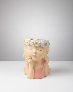 Decorative planter shaped like a girl with a flower crown on a white background