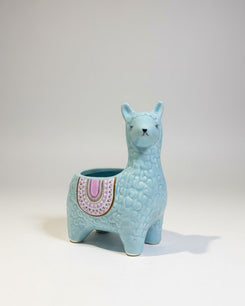 Blue llama-shaped planter on a white background