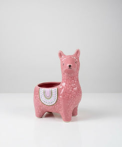 Pink llama-shaped planter on a white background