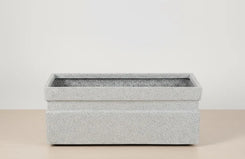 Rectangular stone-patterned planter on a neutral background